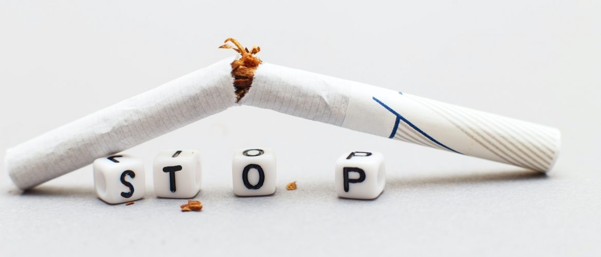 broken cigarette with the word stop on a gray background close. stop smoking concept.banner