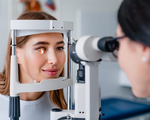 Eye doctor with female patient during an examination in modern clinic